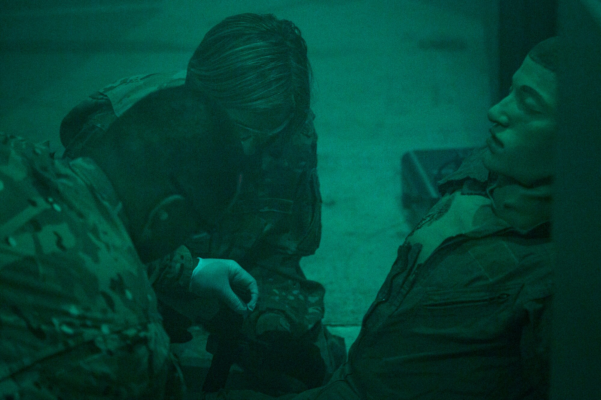 Col. Jennifer Short, center, 23d Wing commander, applies a combat application tourniquet on a simulated trauma victim during an immersion tour, July 23, 2018, at Moody Air Force Base, Ga. During the immersion, Short visited with Survival, Evasion, Resistance, Escape (SERE) and medical specialists from the 347th Operations Support Squadron (OSS). The 347th OSS rescue training center houses both independent duty medical technician paramedics and SERE specialists, whose mission is to train and equip Airmen to be able to survive and save lives while in austere environments. (U.S. Air Force photo by Airman 1st Class Erick Requadt)