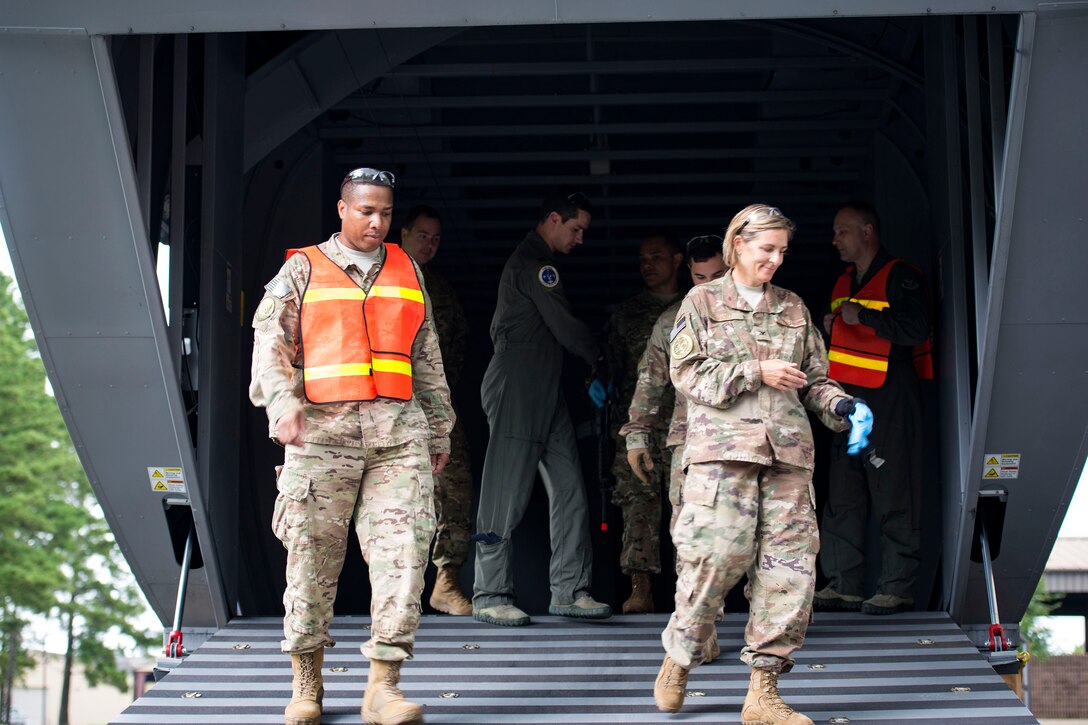 Col. Jennifer Short, right, 23d Wing commander, exits Moody’s HC-130J Combat King II simulator during an immersion tour, July 23, 2018, at Moody Air Force Base, Ga. During the immersion, Short visited with Survival, Evasion, Resistance, Escape (SERE) and medical specialists from the 347th Operations Support Squadron (OSS). The 347th OSS rescue training center houses both independent duty medical technician paramedics and SERE specialists, whose mission is to train and equip Airmen to be able to survive and save lives while in austere environments. (U.S. Air Force photo by Airman 1st Class Erick Requadt)