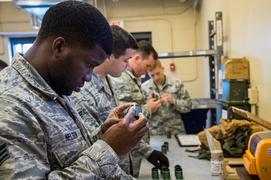 Munition inspectors from the 23rd Maintenance Squadron examine 40 mm projectile explosive shells at Moody Air Force Base, Ga., July 10, 2018. Munitions inspectors enhance Moody’s combat capabilities by inspecting and approving safe and serviceable ammunition. Air Force photo by Airman 1st Class Eugene Oliver