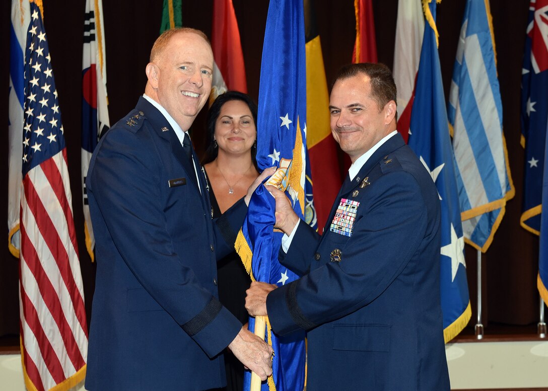 Lt. Gen. Robert McMurray, Air Force Lifecycle Management Center commander, passes the U.S. Air Force flag to Brig. Gen. Sean Farrell as he assumes command of the Air Force Security Assistance and Cooperation Directorate at Wright-Patterson Air Force Base, Ohio, July 18, 2018. Farrell’s previous assignment prior to commanding AFSAC was Director, Strategic Plans, Programs and Requirements, Air Force Special Operations Command, Hurlburt Field, Florida. (U.S. Air Force photo by Al Bright)