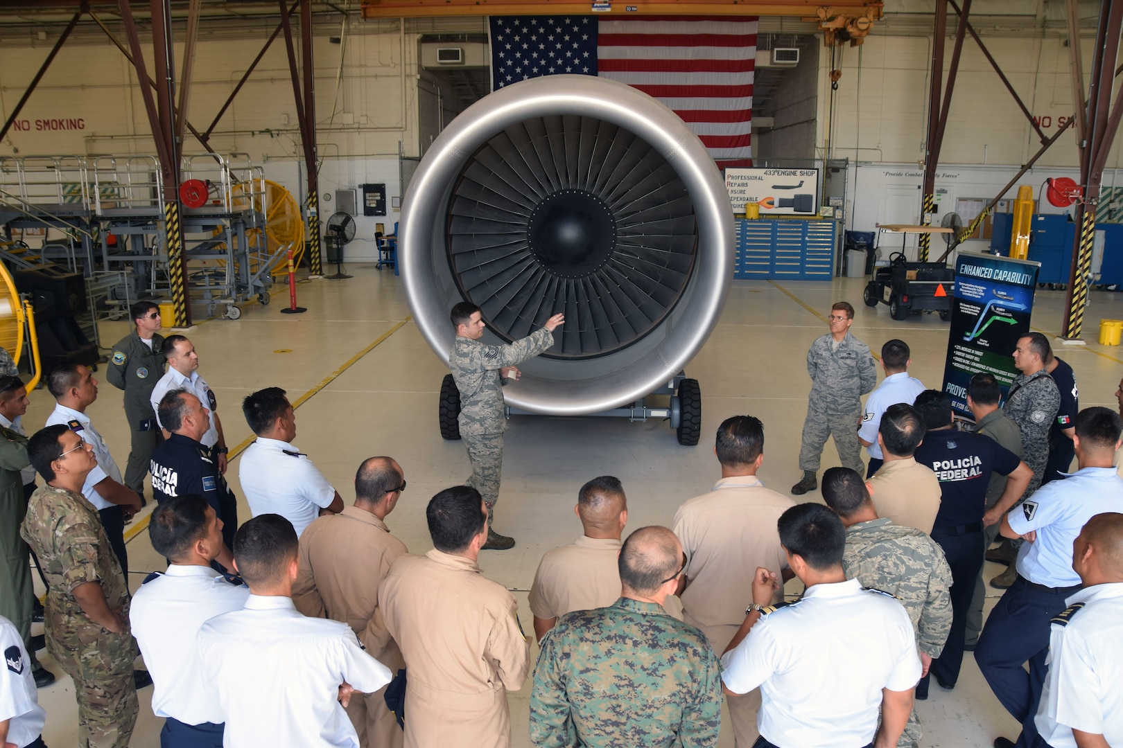 Tech. Sgt. Corey D. Murphy, 433rd Maintenance Squadron aerospace propulsion technician, briefs 40 students from the Inter-American Air Forces Academy ,on the new GE CF6-80C2 turbofan engine that the C-5M Super Galaxy aircraft uses July 18 at Joint Base San Antonio-Lackland. IAAFA students are from Latin American nations who study courses taught in Spanish in subjects ranging from professional military education, operations and support to aircraft and systems training.