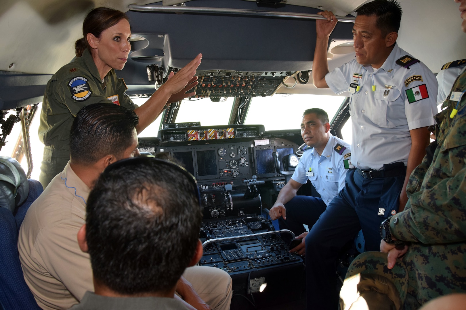 U.S. Air Force Maj. Brandi King, 356th Airlift Squadron C-5M Super Galaxy instructor pilot, talks with students from the Inter-American Air Forces Academy July 18 at Joint Base San Antonio-Lackland. The students are senior maintenance officers in their respective countries’ air forces from Latin America.