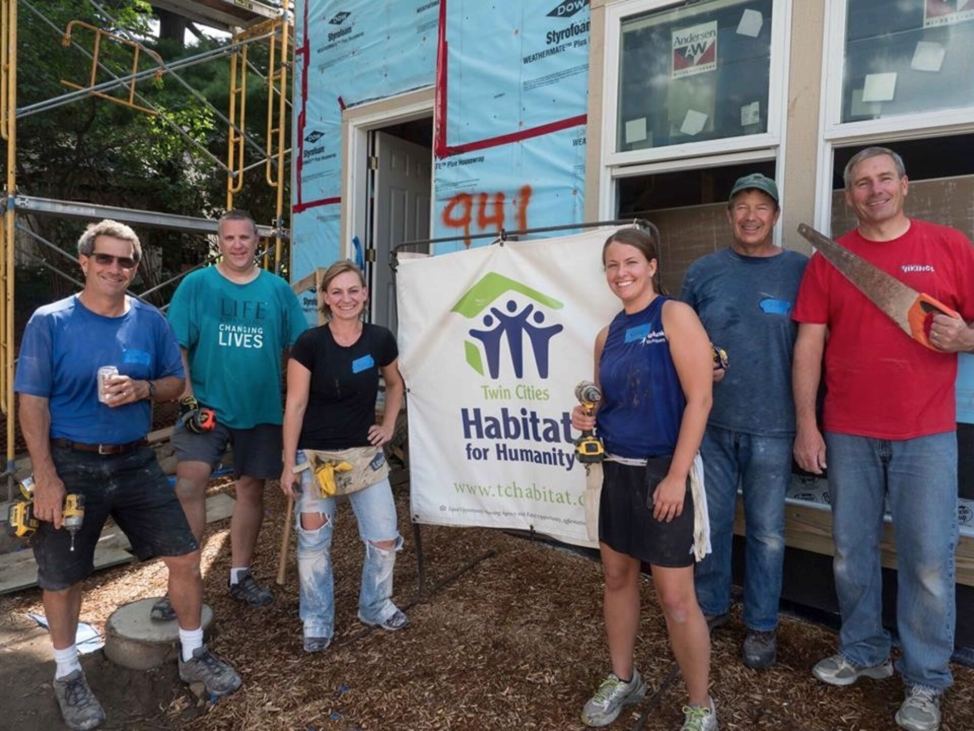 Global Vikings volunteer at Habitat for Humanity project in West St. Paul July 20. From left are Tom O'Reilly, Matt Welage, Master Sgt. Kelly Conley, Staff Sgt. Kayla Bowell, John Rudin and Col. Tim Wollmuth. (Air Force Photo/Paul Zadach)