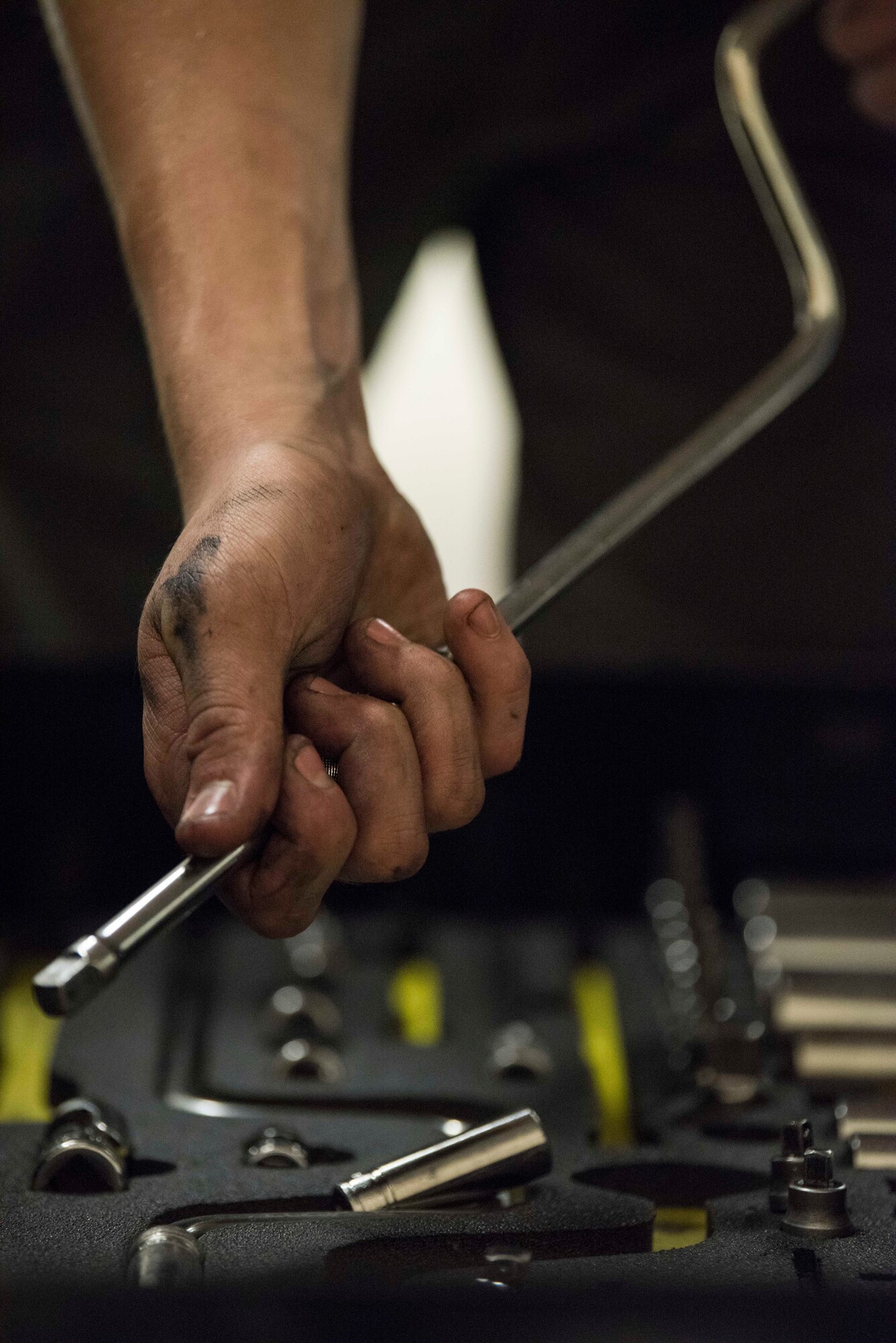Airman 1st Class Ian Pierce, a 525th Aircraft Maintenance Unit F-22 Raptor assistant dedicated crew chief, grabs a three-eighths inch drive speed handle out of his toolbox at Joint Base Elmendorf-Richardson, Alaska, July 18, 2018. Pierce uses standardized and specialty tools to ensure every component of these high-performance aircraft is maintained to precise standards.