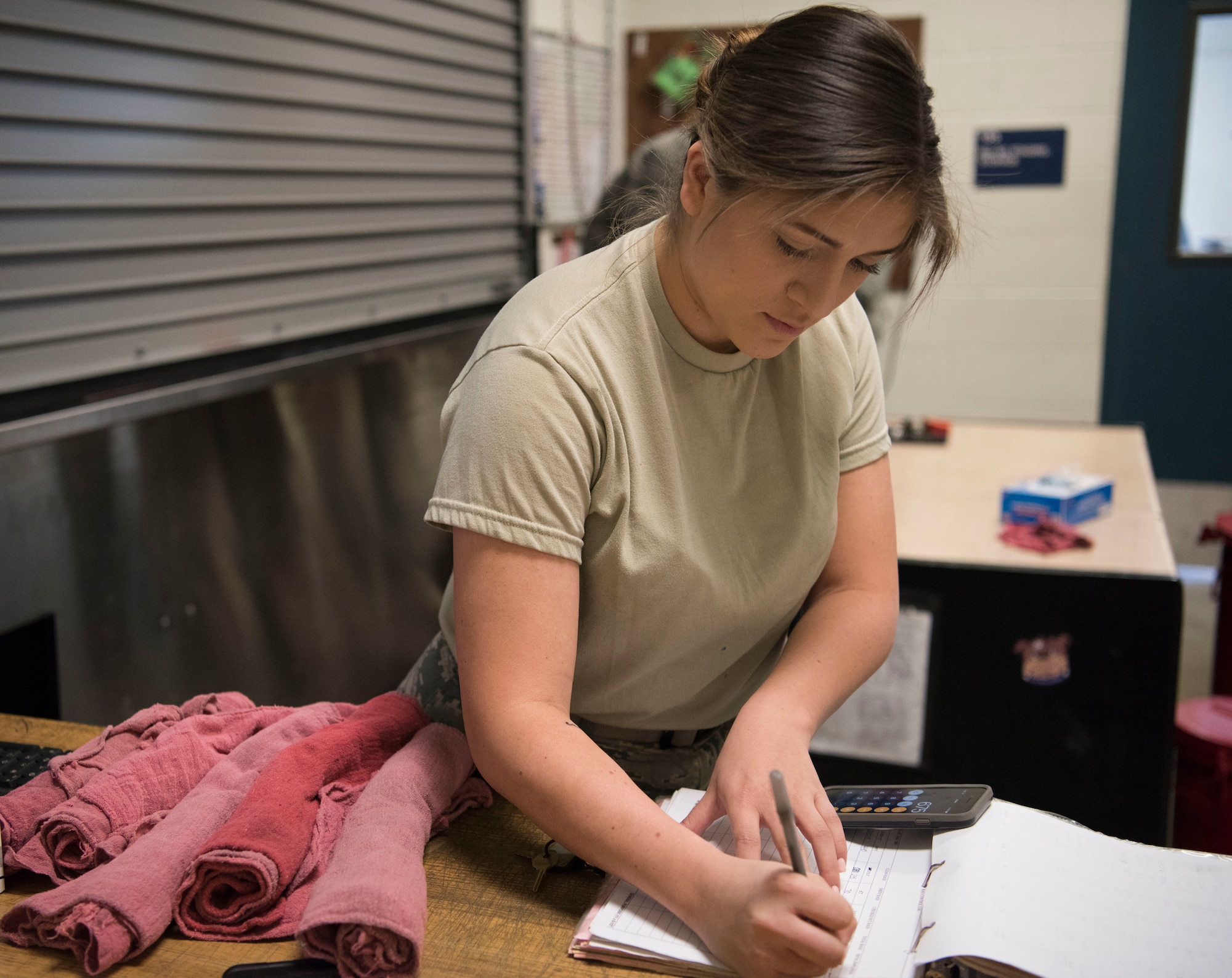 Senior Airman Isabella Ospina, a 525th Aircraft Maintenance Unit F-22 Raptor crew chief support technician, counts shop towels during a tool and equipment shift inventory at Joint Base Elmendorf-Richardson, Alaska, July 19, 2018. Ospina is responsible for the issue and control of more than 10,000 tools during one of three shift inventories.