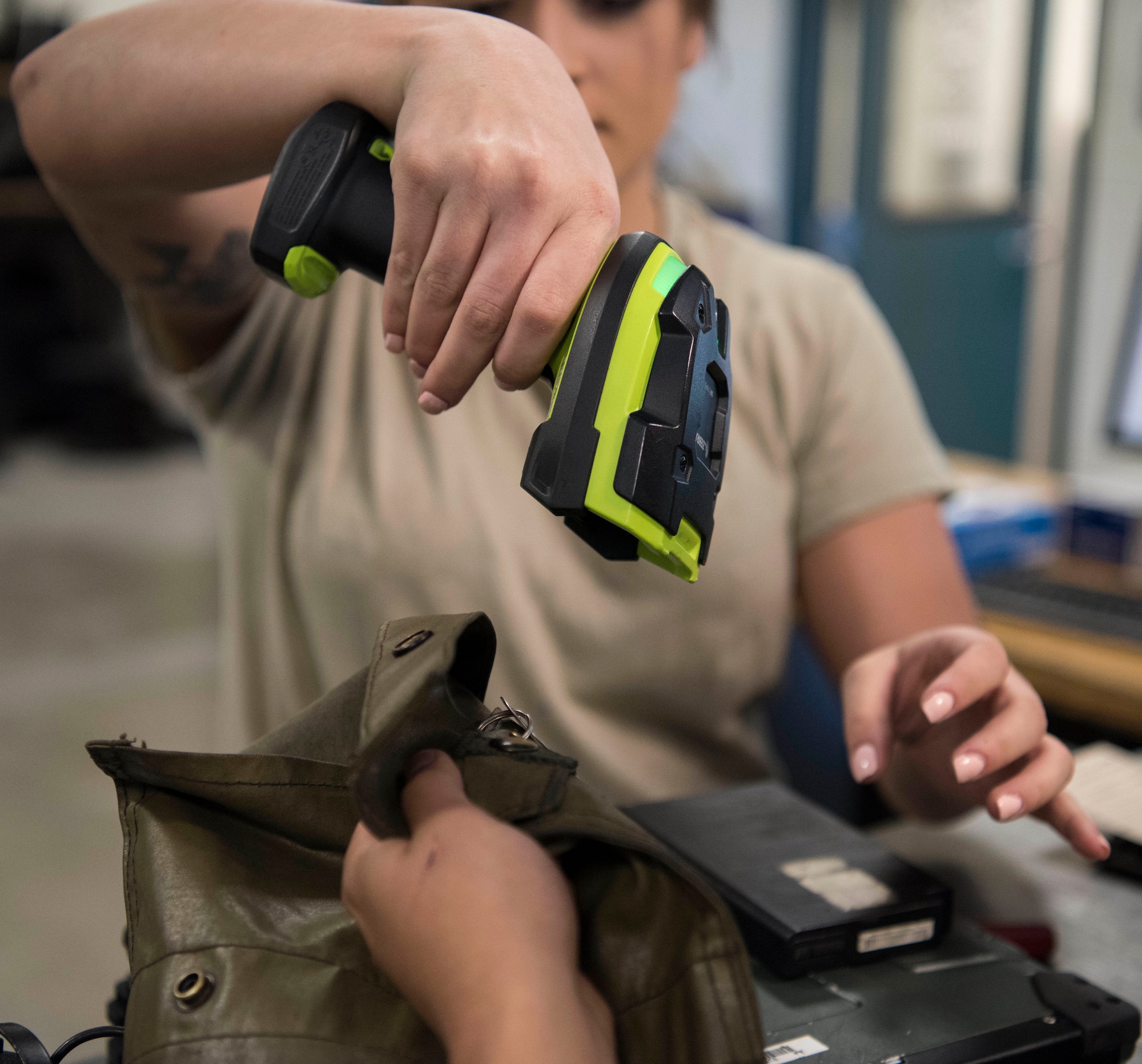 Senior Airman Isabella Ospina, a 525th Aircraft Maintenance Unit F-22 Raptor crew chief support technician, scans tools being checked out during a tool and equipment shift change at Joint Base Elmendorf-Richardson, Alaska, July 19, 2018. Ospina is responsible for the issue and control of more than 10,000 tools during one of three shift inventories.
