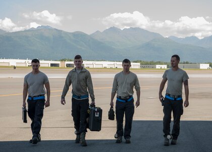 Four 525th Aircraft Maintenance Unit F-22 Raptor crew chiefs begin their shift at Joint Base Elmendorf-Richardson, Alaska, July 19, 2018. Tactical aircraft maintainers are responsible for inspecting the aircraft, fixing any issues that develop during flight, repairing landing gears, engines, hydraulic systems, tire inspection ensuring every component of these high-performance aircraft is maintained to precise standards.