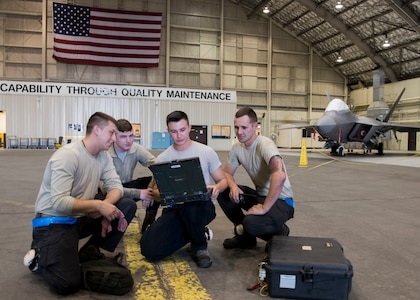 Four 525th Aircraft Maintenance Unit F-22 Raptor crew chiefs discuss a job at the beginning of their shift at Joint Base Elmendorf-Richardson, Alaska, July 19, 2018. Tactical aircraft maintainers are responsible for inspecting the aircraft, fixing any issues that develop during flight, repairing landing gears, engines, hydraulic systems, tire inspection ensuring every component of these high-performance aircraft is maintained to precise standards.