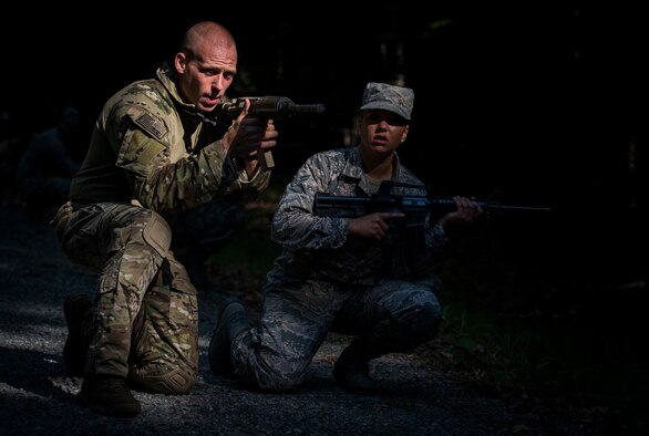 From left, U.S. Air Force Senior Airman Michael Goss, 633rd Civil Engineer Squadron explosive ordnance disposal technician, and Airman 1st Class Katie Bauer, 633rd CES electrical systems apprentice, practice individual movement techniques during Prime Base Engineer Emergency Force training at Joint Base Langley-Eustis, Virginia, July 19, 2018.