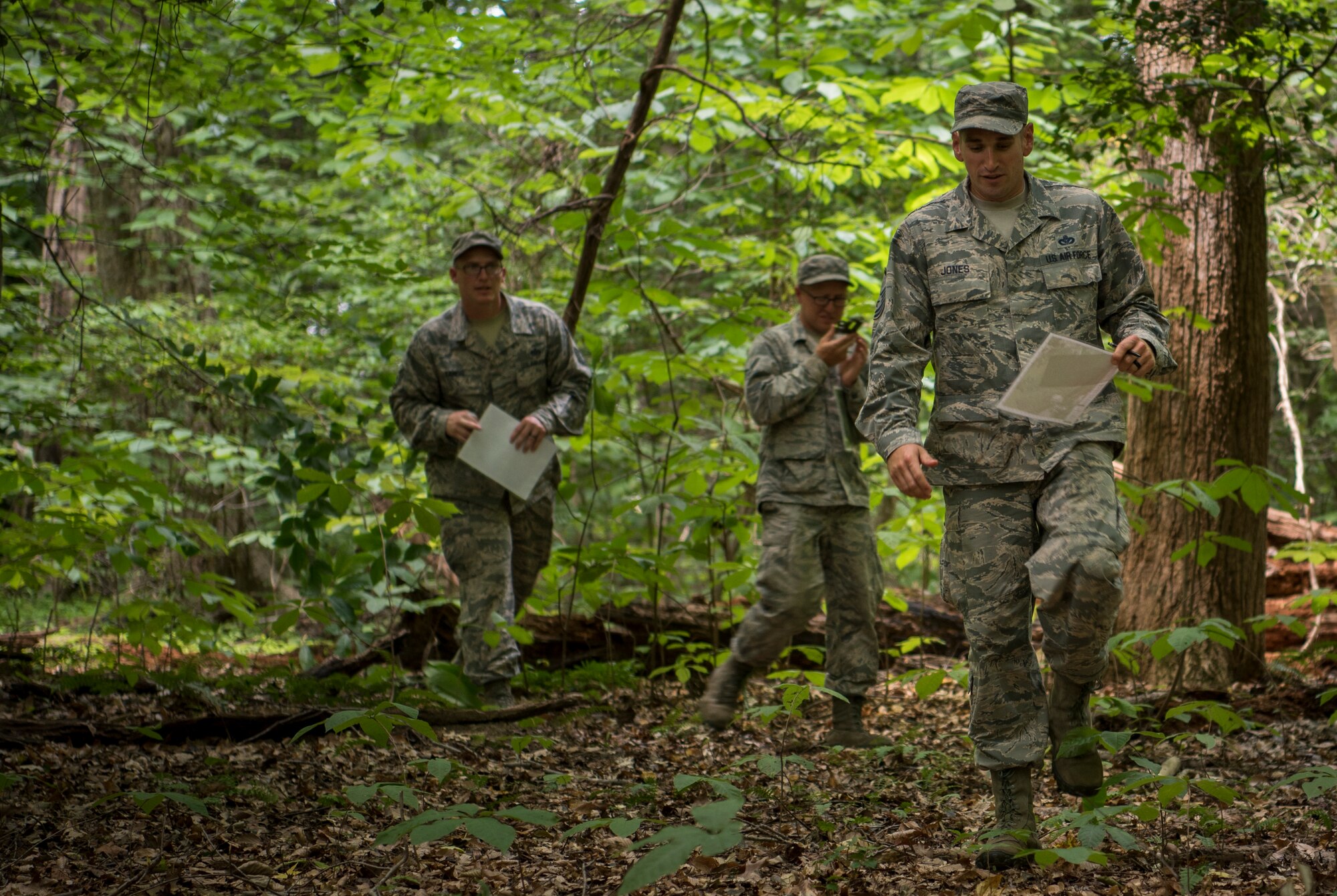 U.S. Air Force Airmen assigned to the 633rd Civil Engineer Squadron practice land navigation during Prime Base Engineer Emergency Force training at Joint Base Langley-Eustis, Virginia, July 19, 2018.