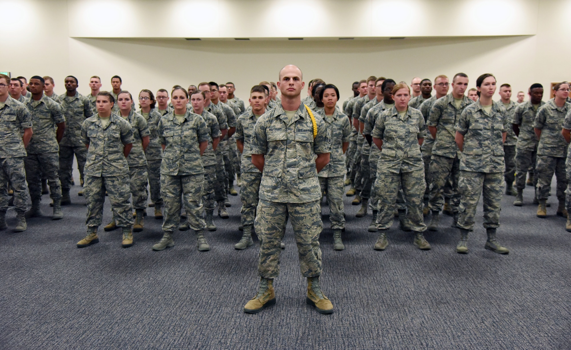 Airmen from the 336th Training Squadron participate in the 336th TRS change of command ceremony in the Roberts Consolidated Aircraft Maintenance Facility at Keesler Air Force Base, Mississippi, July 23, 2018. U.S. Air Force Maj. Jill Heliker, incoming 336th TRS commander, assumed command from Lt. Col. Daniel Schmitt, outgoing 336th TRS commander, with the passing of the guidon. The passing of the guidon is a ceremonial symbol of exchanging command from one commander to another. (U.S. Air Force photo by Kemberly Groue)