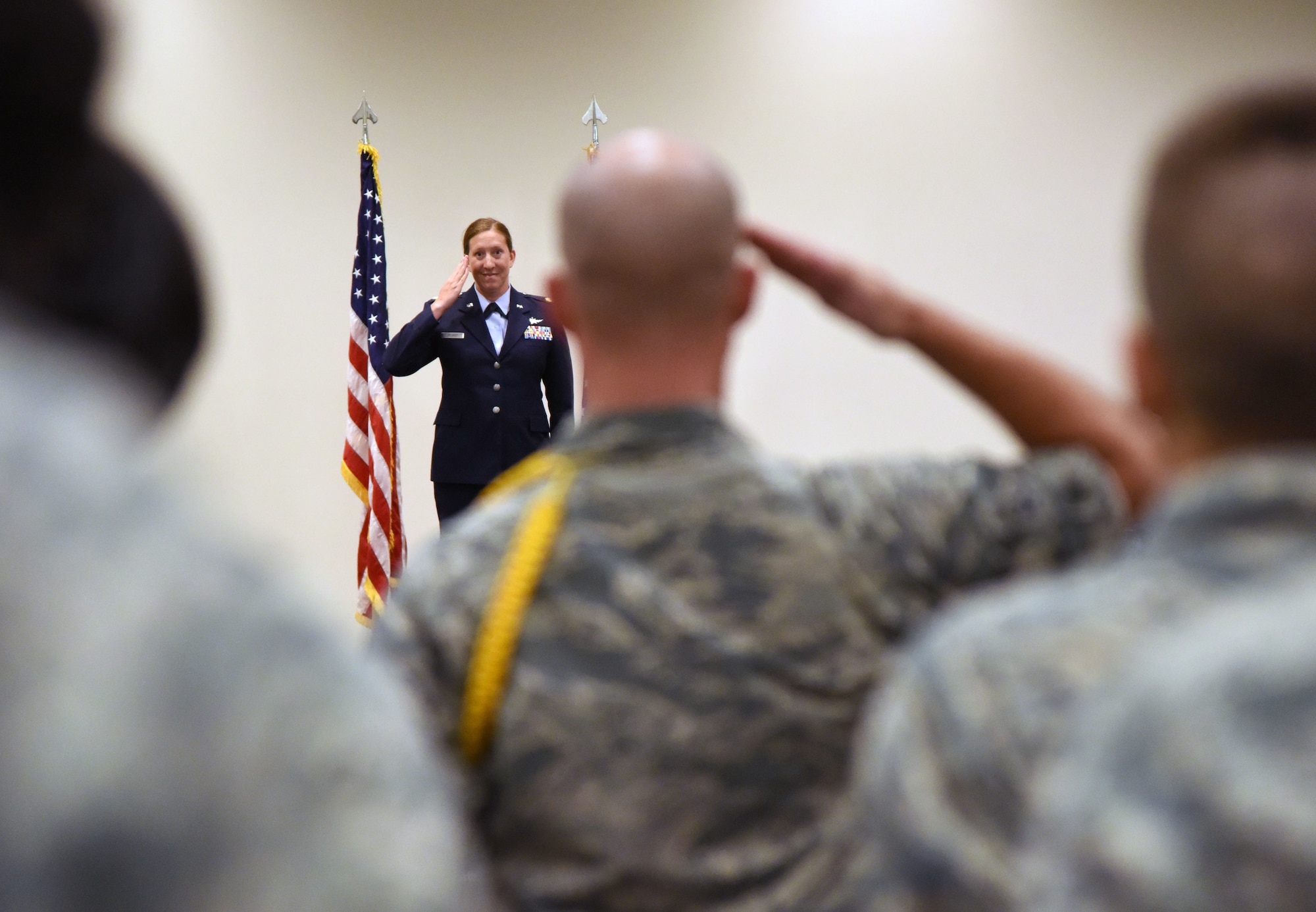 U.S. Air Force Maj. Jill Heliker, 336th Training Squadrom commander, returns a first salute to Airmen during the 336th TRS change of command ceremony in the Roberts Consolidated Aircraft Maintenance Facility at Keesler Air Force Base, Mississippi, July 23, 2018. Heliker assumed command from Lt. Col. Daniel Schmitt, outgoing 336th TRS commander. (U.S. Air Force photo by Kemberly Groue)