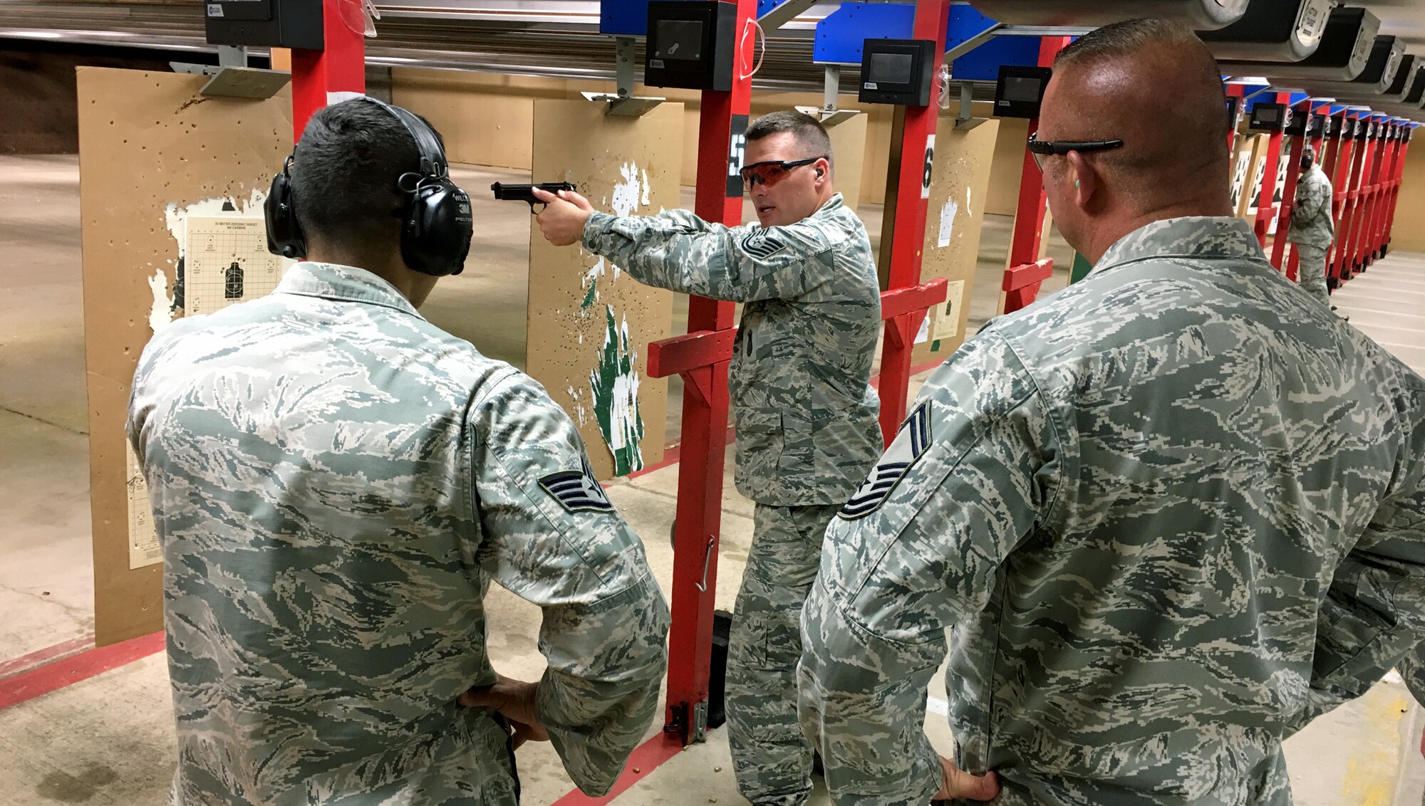 Tech. Sgt. Jared Jeppsen, 419th Security Forces Squadron, gives shooting tips to teammates set to compete in the International Bavarian Military Competition in Germany this week.