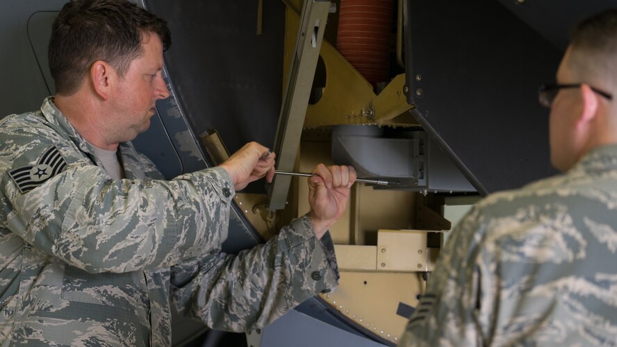 Tech. Sgt. Abraham Partridge, a 403rd Maintenance Squadron intergraded missions systems technician, trains an Airman on avionics equipment at Keesler Air Force Base, Mississippi. Partridge is also a Folk artist and musician. (U.S. Air Force photo by Staff Sgt. Shelton Sherrill)