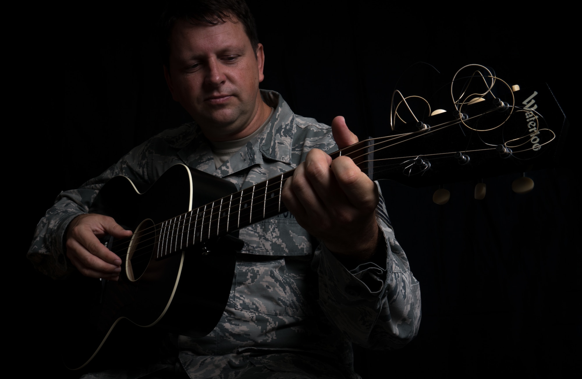 Tech. Sgt. Abraham Partridge, a 403rd Maintenance Squadron intergraded missions systems technician, poses for a portrait with his guitar at Keesler Air Force Base, Mississippi. Partridge’s performs Folk music paints Folk art. (U.S. Air Force photo by Staff Sgt. Shelton Sherrill)
