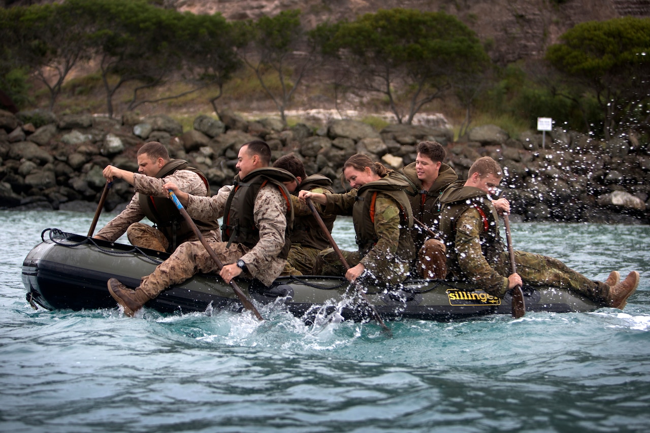U.S. Marines and sailors and Australian Defense Force personnel row a Zodiac boat during exercise Croix Du Sud at Noumea, New Caledonia.
