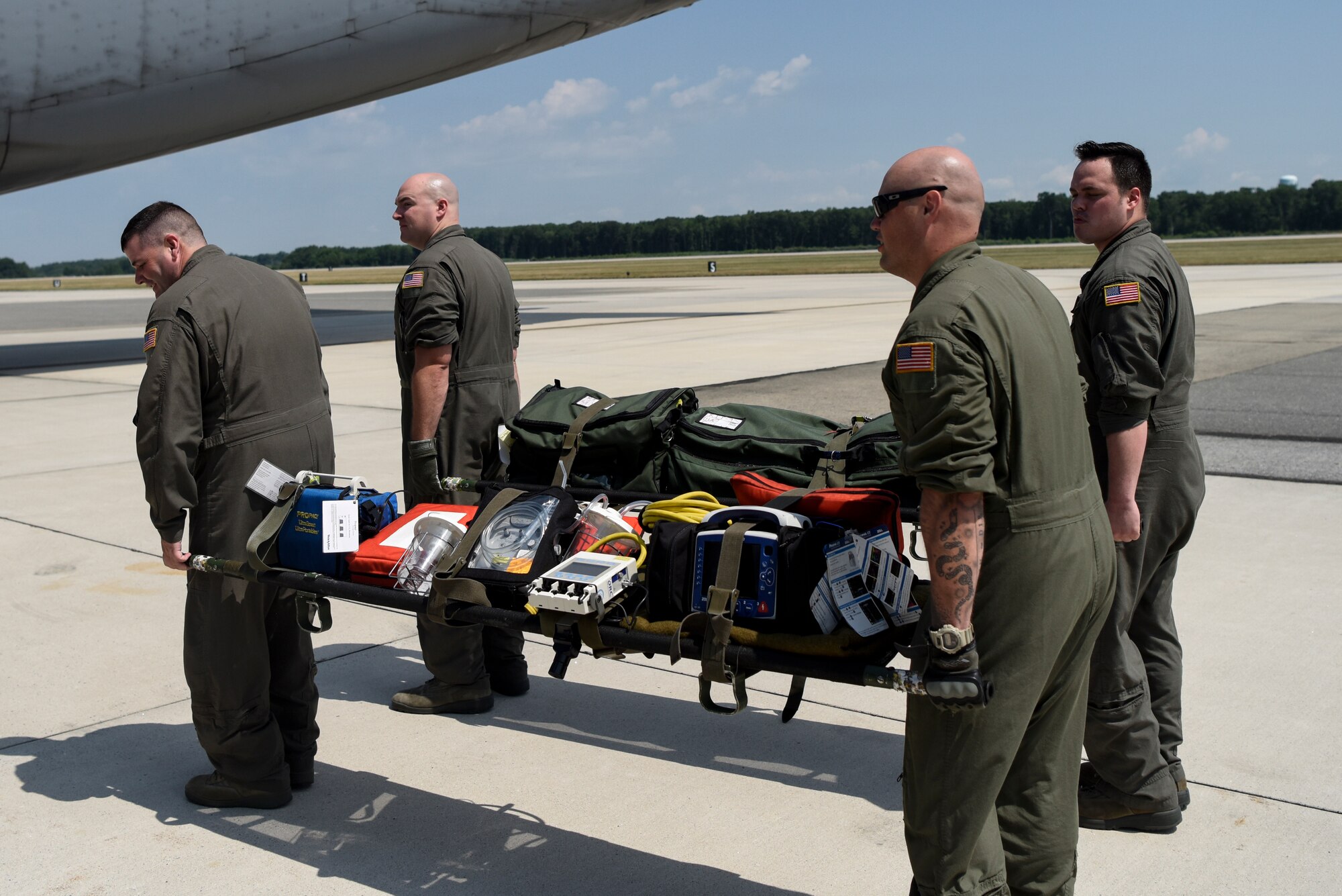 Airmen from the Delaware Air National Guard 142nd Aeromedical Evacuation Squadron carry stretchers with medical equipment July 12, 2018, at Dover Air Force Base, Del. The 142nd AES teamed up with the 9th Airlift Squadron to train aeromedical evacuation procedures on a C-5M Super Galaxy. The 142nd AES is stationed at New Castle Air National Guard Base, Del. (U.S. Air Force photo by Airman 1st Class Zoe M. Wockenfuss)