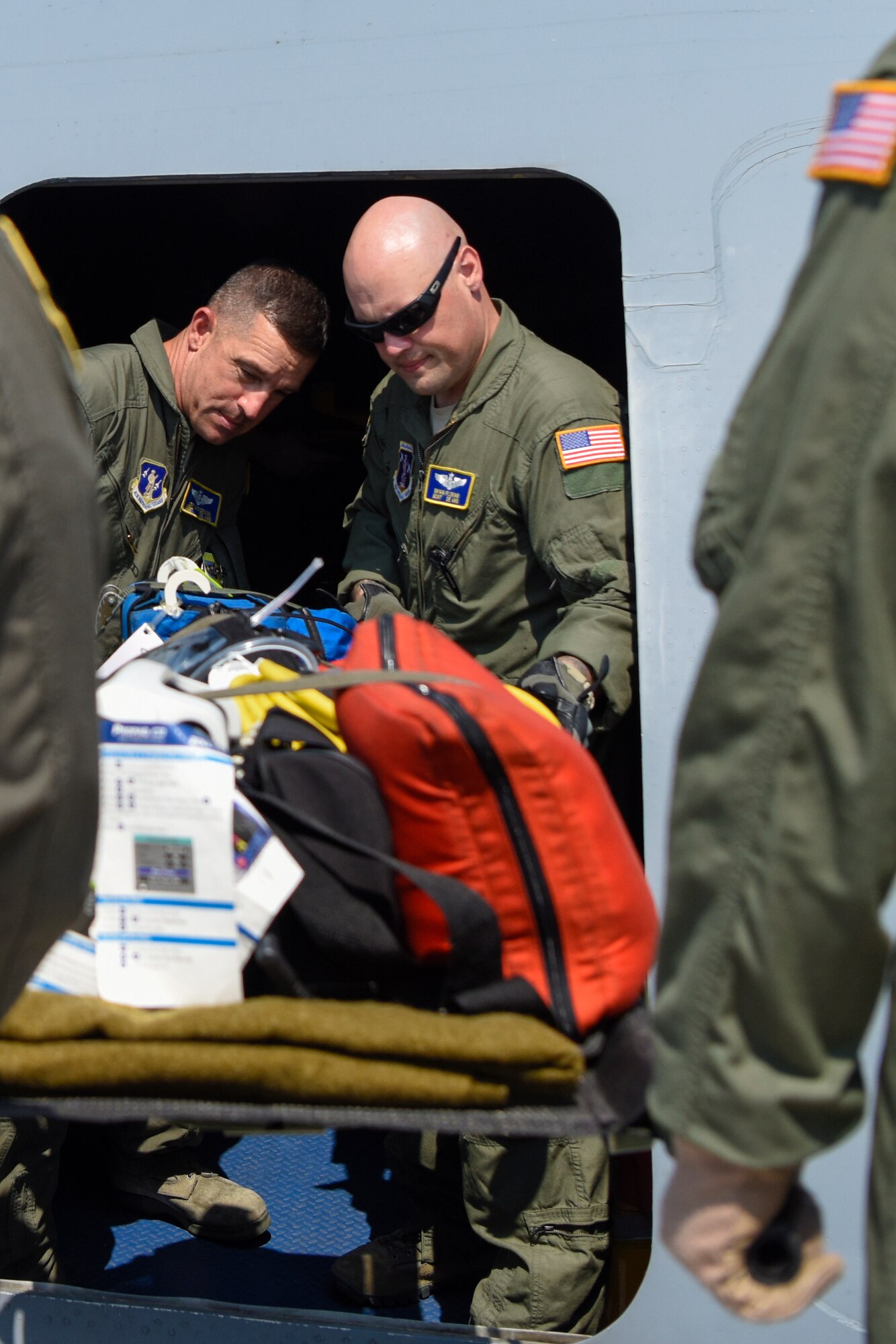 Airmen assigned to the Delaware Air National Guard 142nd Aeromedical Evacuation Squadron load the emergency equipment litter into the troop compartment from a lift truck July 12, 2018, at Dover Air Force Base, Del. The life-saving equipment on the litter is used for monitoring heart rate and vital signs, and can also defibrillate a heart if needed. The 142nd AES is stationed at New Castle Air National Guard Base, Del. (U.S. Air Force photo by Airman 1st Class Zoe M. Wockenfuss)