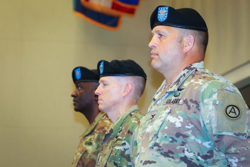 Col. Douglas W. Mills, incoming commander of the 2503rd Digital Liaison Detachment, Maj. Gen. David C. Hill, deputy commanding general, U.S. Army Central, and Col. Oscar W. Doward Jr., outgoing commander of the 2503rd DLD, stand at attention during a change-of-command ceremony July 19, 2018, at Patton Hall on Shaw Air Force Base, S.C. (U.S. Army photo by Sgt. Von Marie Donato)