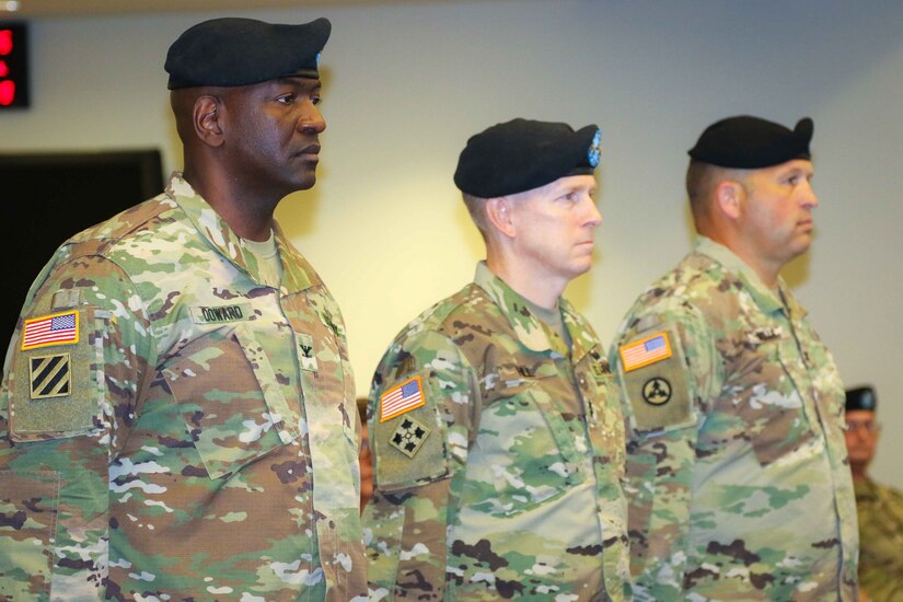 Col. Oscar W. Doward Jr., outgoing commander of the 2503rd Digital Liaison Detachment, Maj. Gen. David C. Hill, deputy commanding general, U.S. Army Central, and Col. Douglas W. Mills, incoming commander of the 2503rd DLD, stand at attention during a change-of-command ceremony July 19, 2018, at Patton Hall on Shaw Air Force Base, S.C. (U.S. Army photo by Sgt. Von Marie Donato)