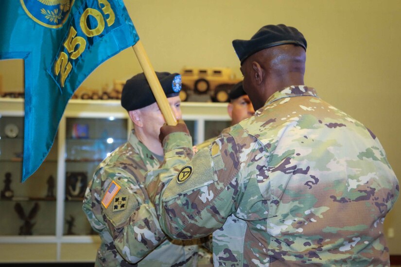(From right to left) Col. Oscar W. Doward Jr., outgoing commander of the 2503rd Digital Liaison Detachment, passes the unit colors to Maj. Gen. David C. Hill, deputy commanding general, U.S. Army Central, during a change-of-command ceremony July 19, 2018, at Patton Hall on Shaw Air Force Base, S.C. (U.S. Army photo by Sgt. Von Marie Donato)