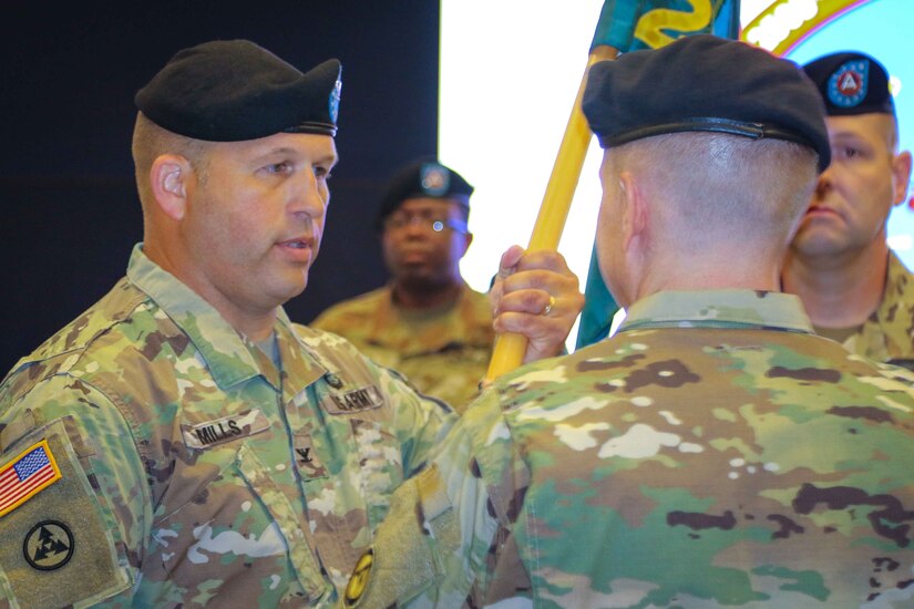 Col. Douglas W. Mills, incoming commander of the 2503rd Digital Liaison Detachment, receives the unit colors from Maj. Gen. David C. Hill, deputy commanding general, U.S. Army Central, during a change-of-command ceremony July 19, 2018, at Patton Hall on Shaw Air Force Base, S.C. (U.S. Army photo by Sgt. Von Marie Donato)