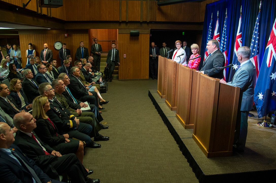 Defense Secretary James N. Mattis, Secretary of State Michael R. Pompeo and Australian leaders speak to a room of people from podiums.