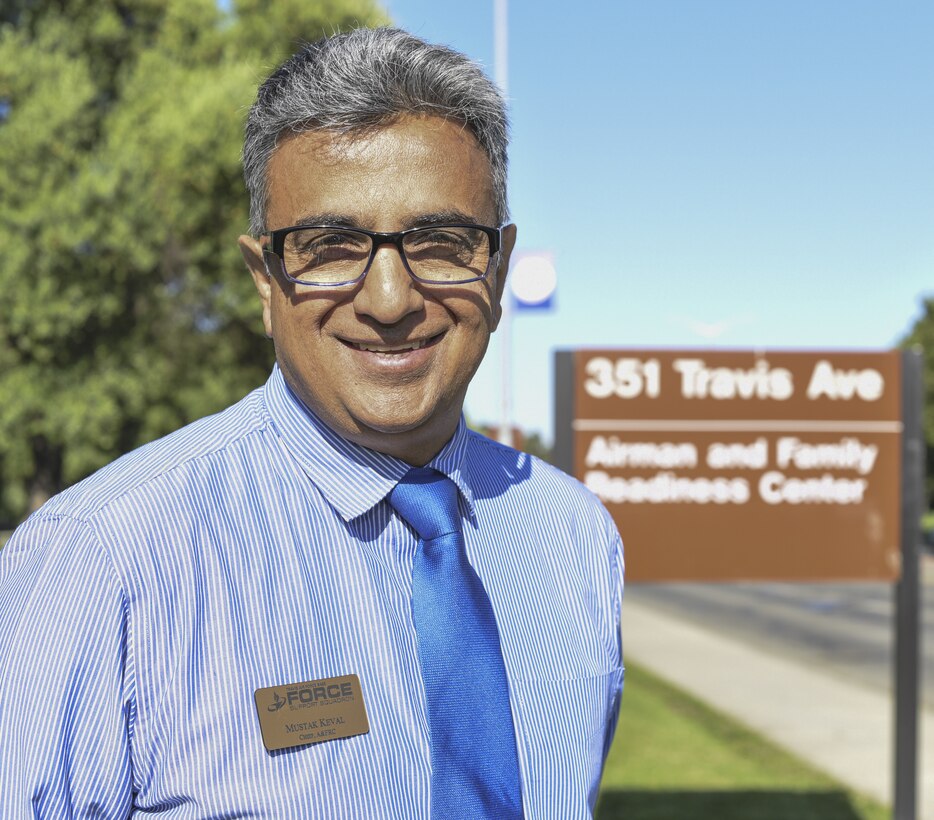 Mustak Keval, 60th Force Support Squadron Airman and Family Readiness Center flight chief, poses for a photo July 23, 2018, at Travis Air Force Base, Calif. Keval, a Ugandan refugee spent more than 20 years in the U.S. Air Force and continues to serve Airmen and their families at the AFRC. (U.S. Air Force photo by Staff Sgt. Amber Carter)