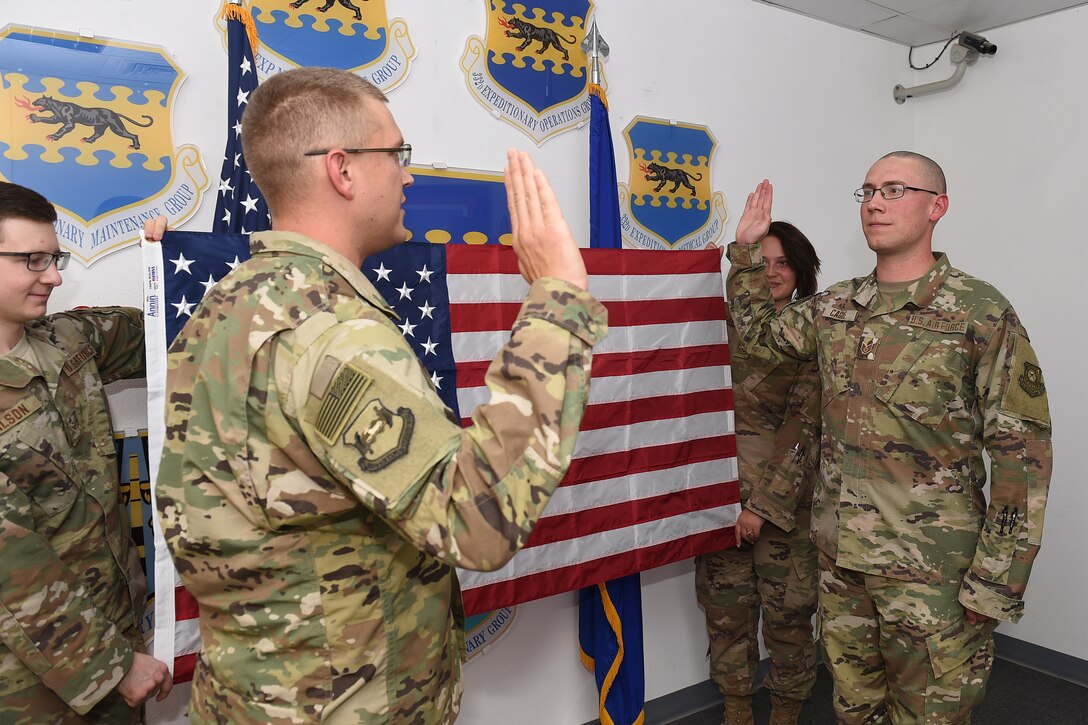 An Airmen reads the oath of enlistment to his brother