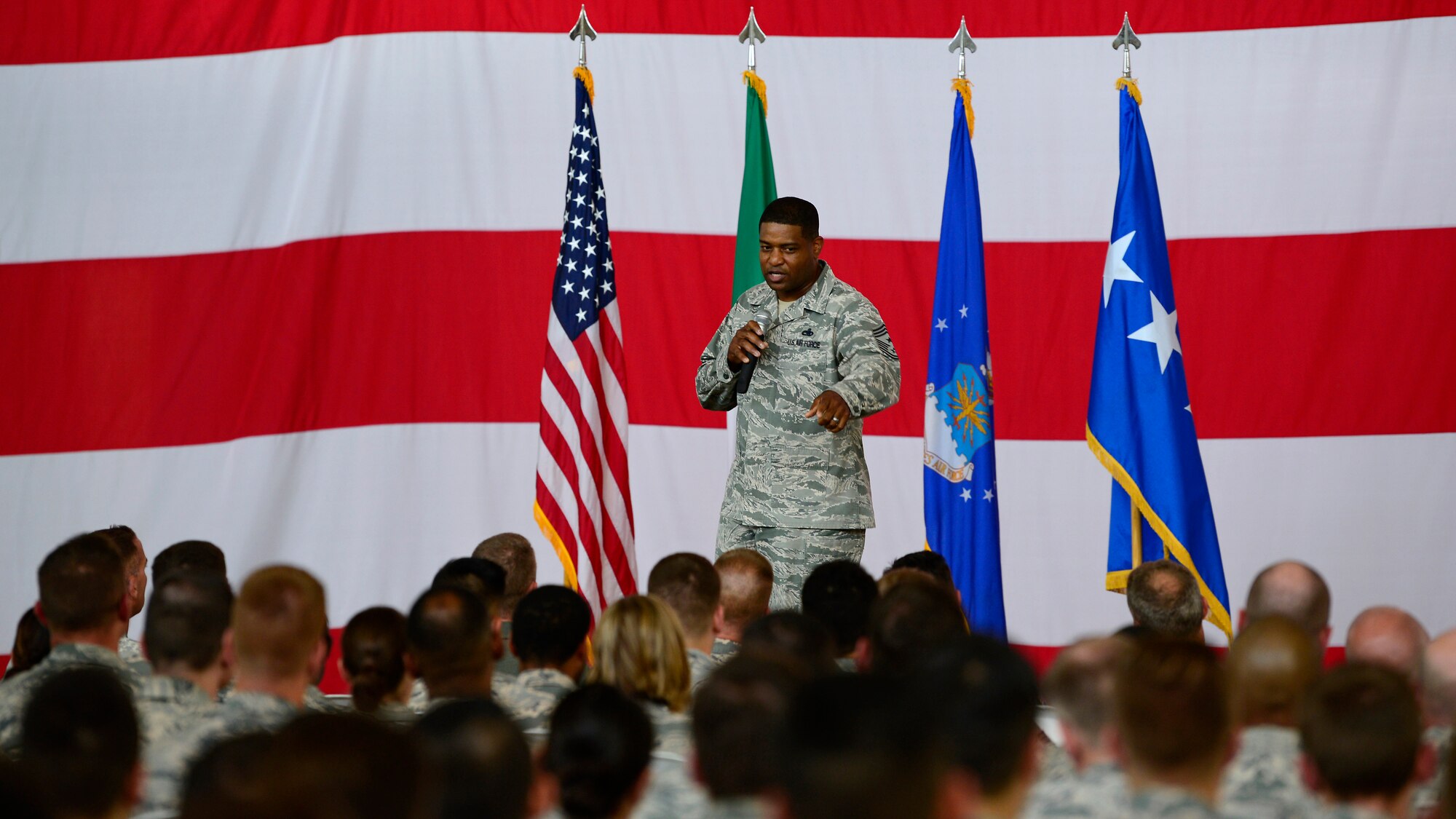 Chief Master Sgt. Phillip L. Easton, U.S. Air Forces in Europe and Air Forces Africa command chief, speaks with Airmen at an all call during a visit to Aviano Air Base, Italy, July 23, 2018. Easton spoke on the importance of Airmen and families to take time to recharge and come back to complete the mission safely and efficiently. (U.S. Air Force photo by Staff Sgt. Cary Smith)