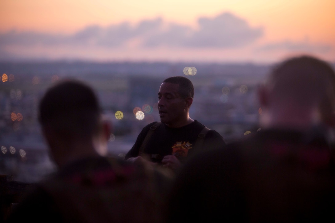 Master Sgt. Eric C. Hernandez, the guest speaker of Corporals Course class 576-18 and the operations chief of Communications Company, Headquarters Regiment, 3rd Marine Logistics Group, expresses his thoughts on being a corporal to the course July 25, 2018 at Hacksaw Ridge, Okinawa, Japan. The class ran 3.6 miles to Hacksaw Ridge and back as part of the physical training for the course. Hernandez is a native of Forest Hills, New York.