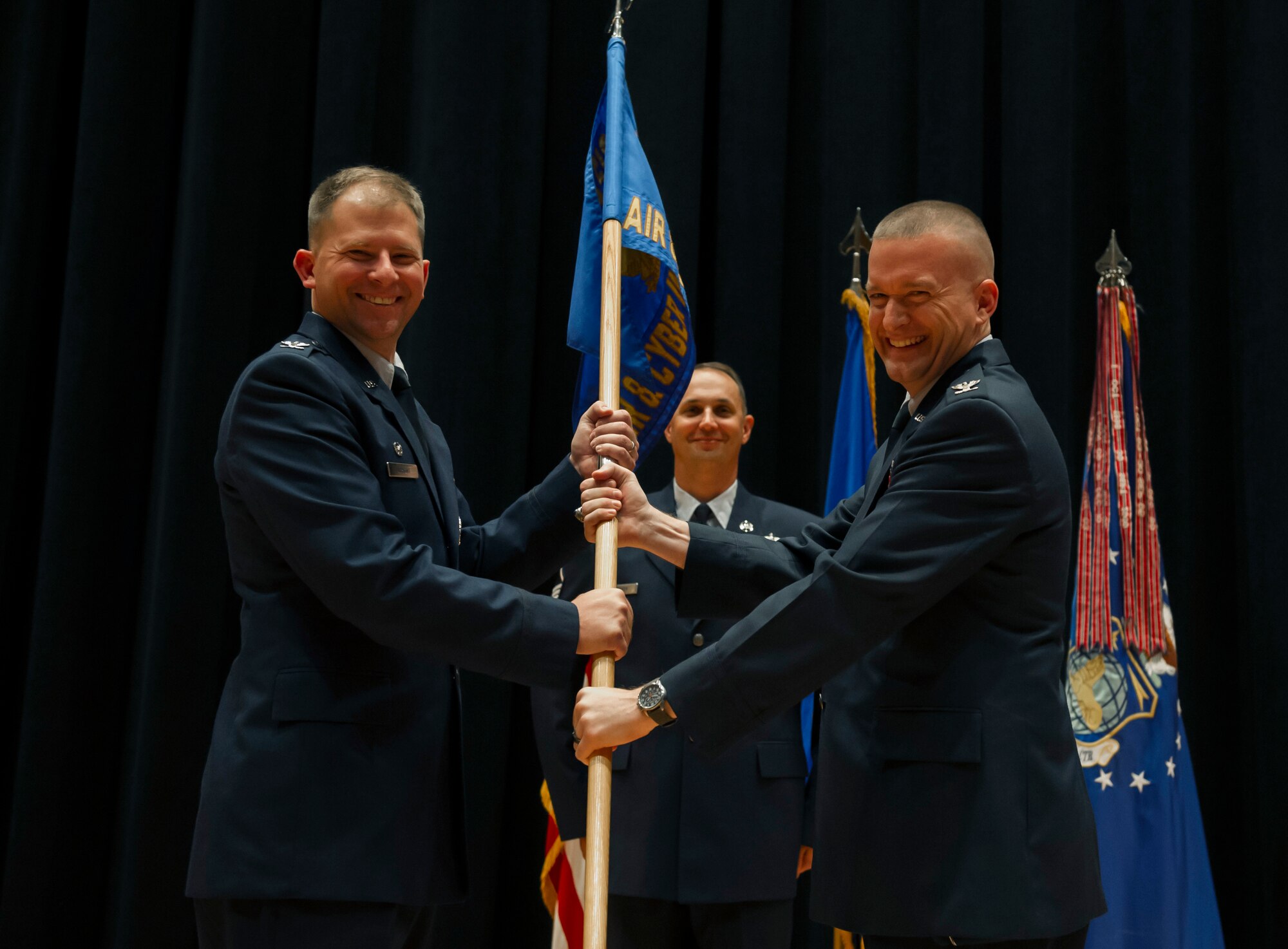 Col. William Fry accepts command of the National Air and Space Intelligence Center’s Air and Cyberspace Intelligence Group from Col. Parker Wright, NASIC commander, July 20. AC is responsible for the production of original intelligence assessments on foreign air systems, electronics, directed energy, integrated air defense, and cyberspace systems supporting the warfighter, national policy makers and the acquisitions community. (U.S. Air Force photo/ Senior Airman Jonathan Stefanko)