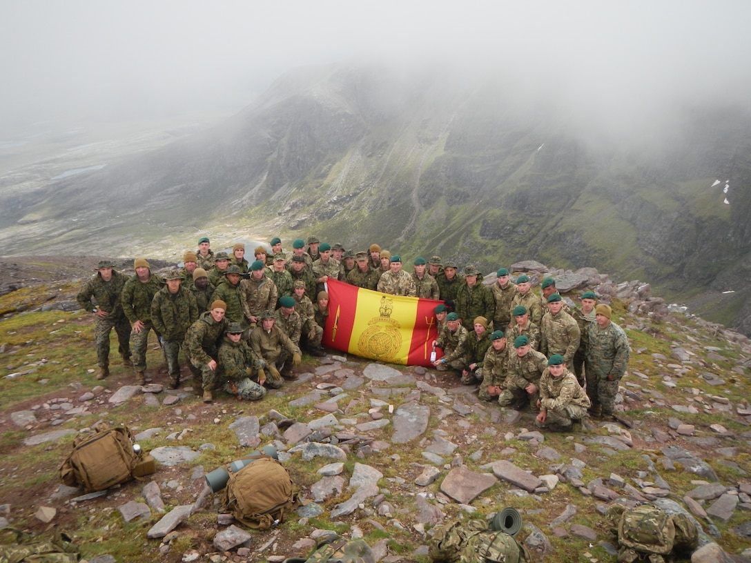 Col. Brian W. Neil, commander, U.S. Marine Corps Security Forces Regiment, poses with Marines from MCSF battalion Bangor and MCSF battalion Kings Bay, along with their counterparts from the British Royal Marines on their hike of An Teallach Mountain in Scotland, UK. This was part of the joint exercise, Operation Tartan Eagle, in which US Marines went to train with the British Royal Marines in the UK. (Official U.S. Marine Corps photo by Capt. Joseph Trippi/ Released)