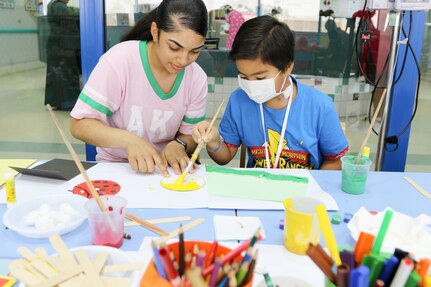 Spc. Maigen DiCristofaro with Headquarters & Headquarters Company, 38th Sustainment Brigade, Indiana National Guard, joined Ahmad to create a colorful artwork on a CD at NBK children’s hospitals on July 10, 2018. Soldiers volunteered their day with the Kuwait Association for the Care of Children in Hospital (KACCH) play therapy day through Task Force Spartan’s participation in the Every Soldier an Ambassador program.