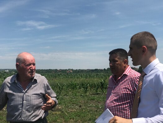 Second lieutenant Ioan Gaitan, (at right) materiel management flight commander assigned to the 97th Logistics Readiness Squadron at Altus Air Force Base, Okla., discusses a WWII aircraft crash with a Romanian local and the mayor of his village in Romania. Gaitan traveled to Romania to serve as a translator for the Defense POW/MIA Accounting Agency Language Enabled Airman Program. (Courtesy photo by U.S. Air Force 2nd Lt. Ioan Gaitan)