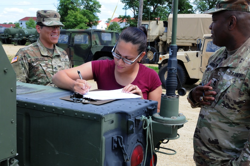 Isavette Torres, center, Fort McCoy Draw Yard, reviews the paperwork for equipment being issued to Soldiers from the 86th Training Division July 18. The Draw Yard operates under the 88th Readiness Division and provides training units with on-site vehicles and equipment that save training time and money.