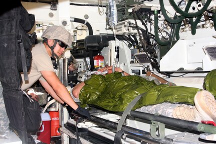 An emergency medicine doctor accompanies a casualty role player as they arrive at the triage location during the mass casualty portion of 2018 Joint Emergency Medical Exercise in mid-June.