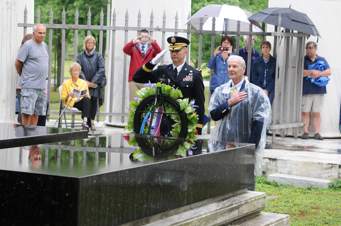 Brigadier Gen. Tony L. Wright, center, deputy commanding general, 88th Readiness Division, and Dr. Warren G. Harding III, great-nephew of former President Warren G. Harding, render honors during the playing of Taps as part of the wreath laying ceremony in Marion, Ohio July 21. Each year, a wreath is placed on behalf of the current president of the United States at the gravesite of Harding and his wife Florence.