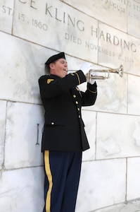 Staff Sgt. Dave Lambermont, bugler, 338th Army Band, 88th Readiness Division, plays taps during the ceremony honoring the service and legacy of Warren G. Harding, the 29th president of the United States, in Marion, Ohio July 21.