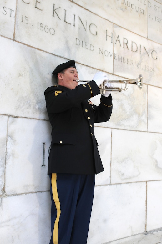 Staff Sgt. Dave Lambermont, bugler, 338th Army Band, 88th Readiness Division, plays taps during the ceremony honoring the service and legacy of Warren G. Harding, the 29th president of the United States, in Marion, Ohio July 21.