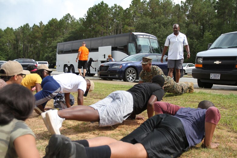 U.S. Marine Corps 1stSgt. James Williams drills dozens of Navy and Marine Corps Junior Reserve Officers Training Corps cadets after arriving on Marine Corps Logistics Base Albany. More than 40 cadets spent an intense five days at MCLB Albany for its first-ever summer camp. Each cadet experienced a week-long taste of basic leadership training. (U.S. Marine Corps photo by Re-Essa Buckels)