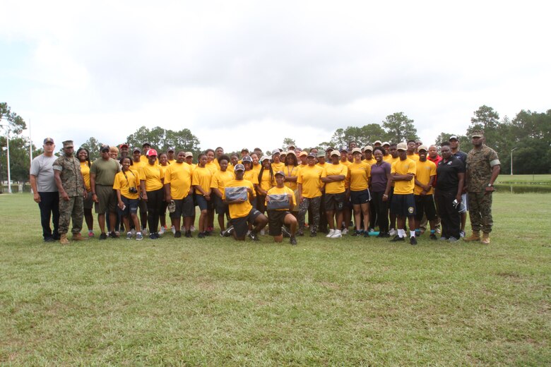 Marine Corps Logistics Base Albany Commanding Officer Colonel Alphonso Trimble (right) and Sergeant Major Johnny Higdon (left) take a group photo with Navy and Marine Corps Junior Reserve Officer Training Corps cadets and their instructors. More than 40 cadets spent an intense five days at Marine Corps Logistics Base Albany for its first-ever summer camp. Each cadet experienced a week-long taste of basic leadership training. (U.S. Marine Corps photo by Re-Essa Buckels)