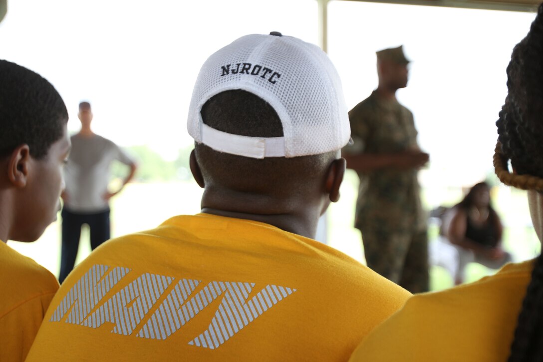 Navy and Marine Corps Junior Reserve Officer Training Corps cadet listens as Marine Corps Logistics Base Albany Commanding Officer Colonel Alphonso Trimble shared his personal career journey with the group. More than 40 cadets spent an intense five days at Marine Corps Logistics Base Albany for its first-ever summer camp. Each cadet experienced a week-long taste of basic leadership training. (U.S. Marine Corps photo by Re-Essa Buckels)