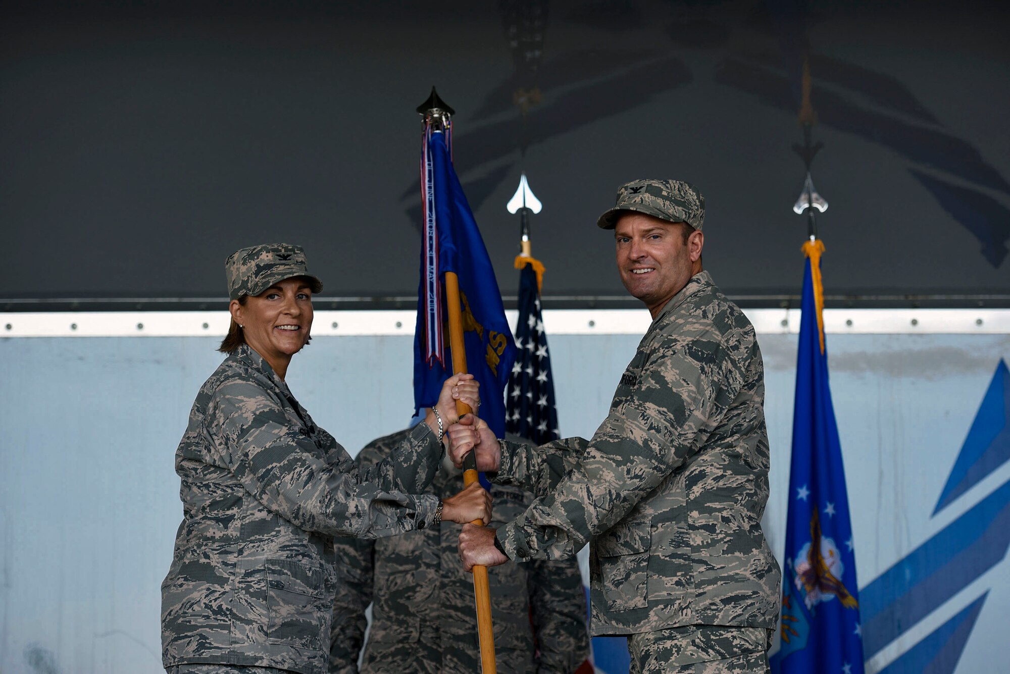 Col. Jennifer Short, left, presents a guidon to Col. Brian Stumpe as he assumes command of the 23d Mission Group during a change of command ceremony, July 25, 2018, at Moody Air Force Base, Ga. Prior to assuming command, Stumpe was the Director of Installations for U.S. Air Forces Central Command (AFCENT), Al Udeid AB, Qatar. He will take command of the 23d MSG, which is comprised of six squadrons with approximately 1,500 personnel dedicated to training, equipping and deploying personnel support forces to build, protect and sustain air bases worldwide for combat air operations. (U.S. Air Force photo by Senior Airman Greg Nash)