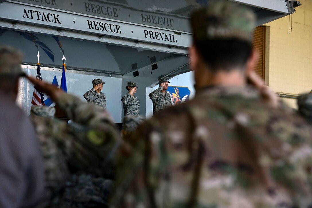 Team Moody Airmen salute during the playing of the national anthem as part of the 23d Mission Support Group’s change of command ceremony, July 25, 2018, at Moody Air Force Base, Ga. The 23d MSG recognized the formal transfer of authority and responsibility as Col. Susan Riordan-Smith relinquished command to Col. Brian Stumpe. The 23d MSG is comprised of six squadrons with approximately 1,500 personnel dedicated to training, equipping and deploying personnel support forces to build, protect and sustain air bases worldwide for combat air operations. (U.S. Air Force photo by Senior Airman Greg Nash)