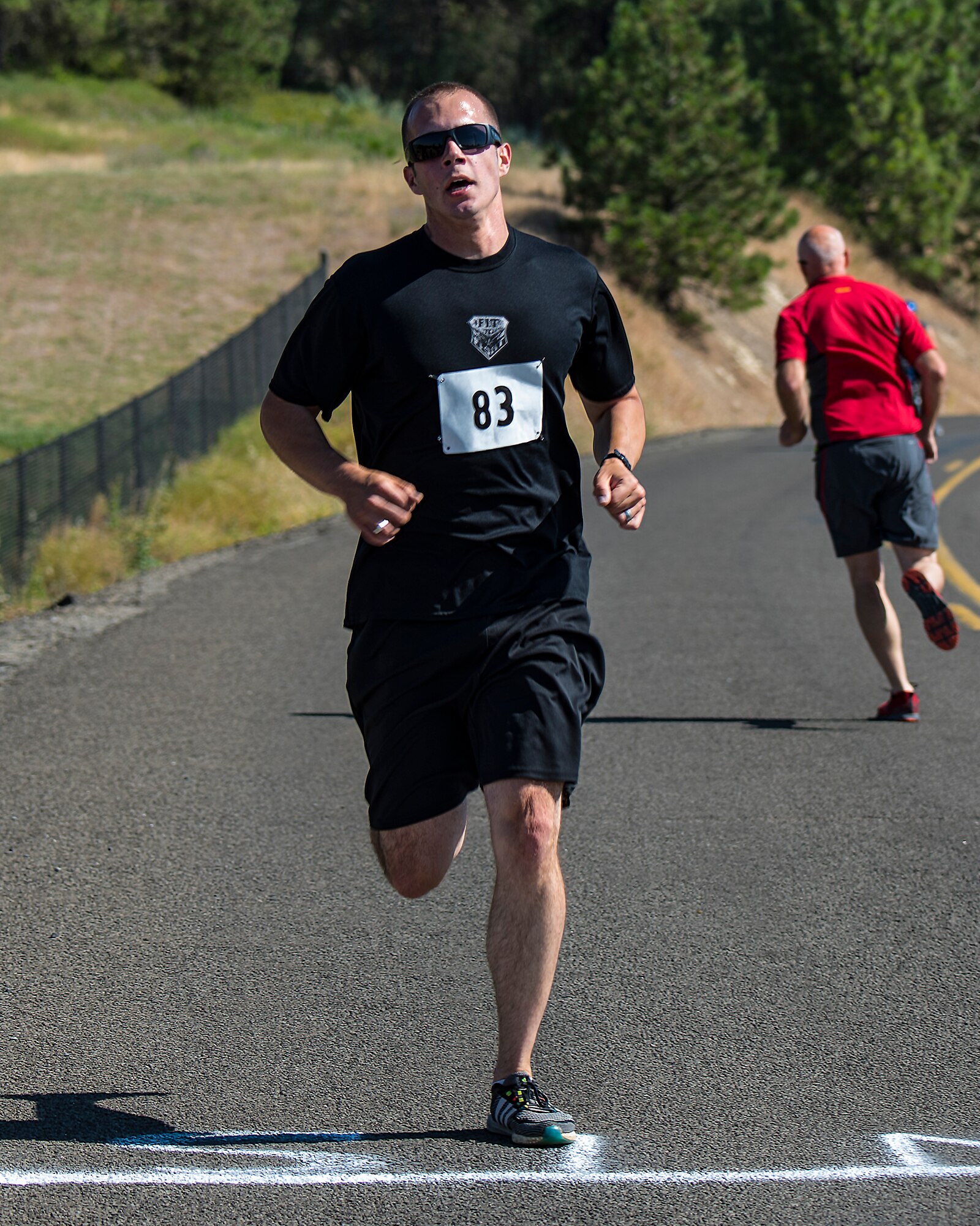 U.S. Air Force 1st Lt. Joshua Klapak, 93rd Air Refueling Squadron pilot, completes the final portion of the 14th annual Clear Lake Triathlon at Medical Lake, Washington, June 21, 2018. The print triathlon has been expertly honed to provide a physically challenging and well-charted course. (U.S. Air Force photo/ Airman 1st ClassWhitney Laine)