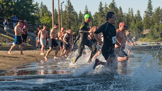 Team Fairchild Airmen begin the 14th annual Clear Lake Triathlon at Medical Lake, Washington, June 21, 2018. The sprint triathlon consisted of a 500 meter swim, 17.5 kilometer bike ride and five kilometer run. (U.S. Air Force photo/Senior Airman Whitney Laine)