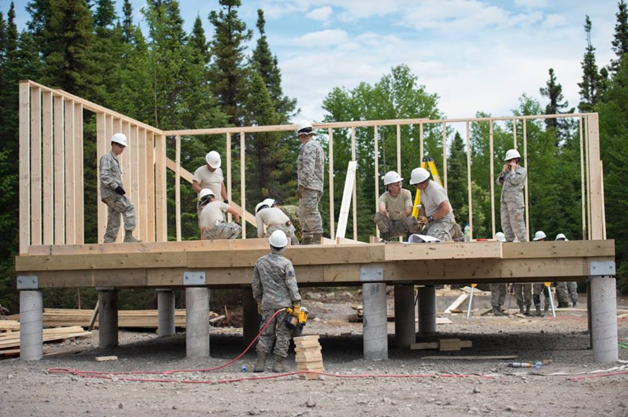 Members of the 149th Civil Engineer Squadron work to build a cabin.