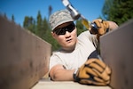 Members of the 149th Civil Engineer Squadron work to build a cabin.