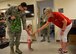 Sandi Meikel, American Red Cross volunteer, gives a military child a simulated Meal Ready to Eat during Operation Kids Understanding Deployment Operations at Fairchild Air Force Base, Washington , July 20, 2018. Operation KUDOS is designed to give children a visual understanding of deployments and provide families an opportunity to bond during an otherwise stressful life event. (U.S. Air Force photo/Airman 1st Class Jesenia Landaverde)